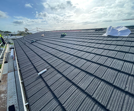 Metal tile roof with ridge capping